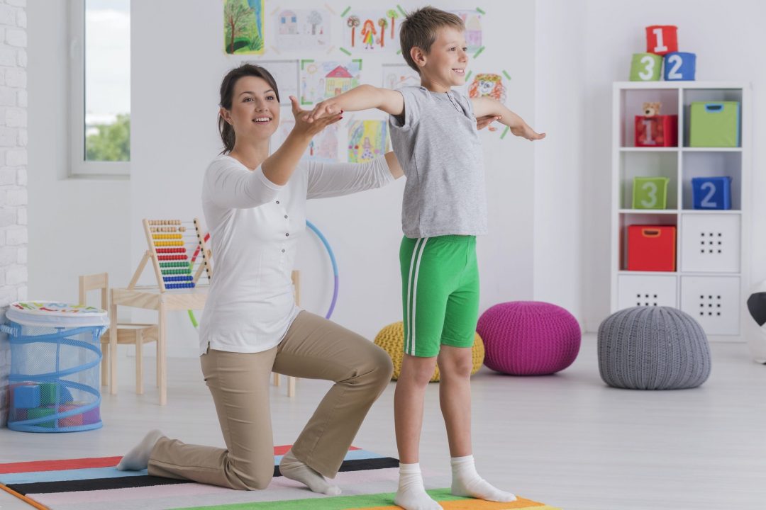 Physiotherapist exercising with a school boy - lighthouse chiropractic | family chiropractic center | fort collins, co | experienced practitioner professionals | fort collins chiropractic care & massage therapy